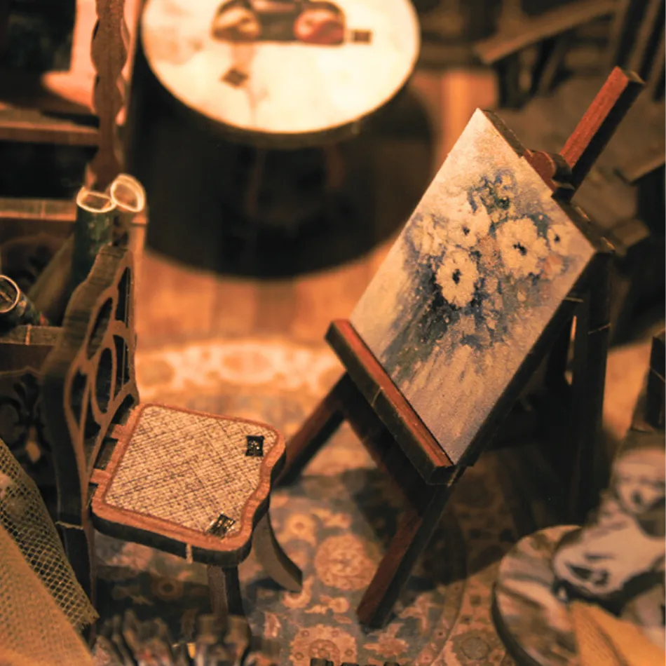 Small wooden easel with a painting on a patterned surface