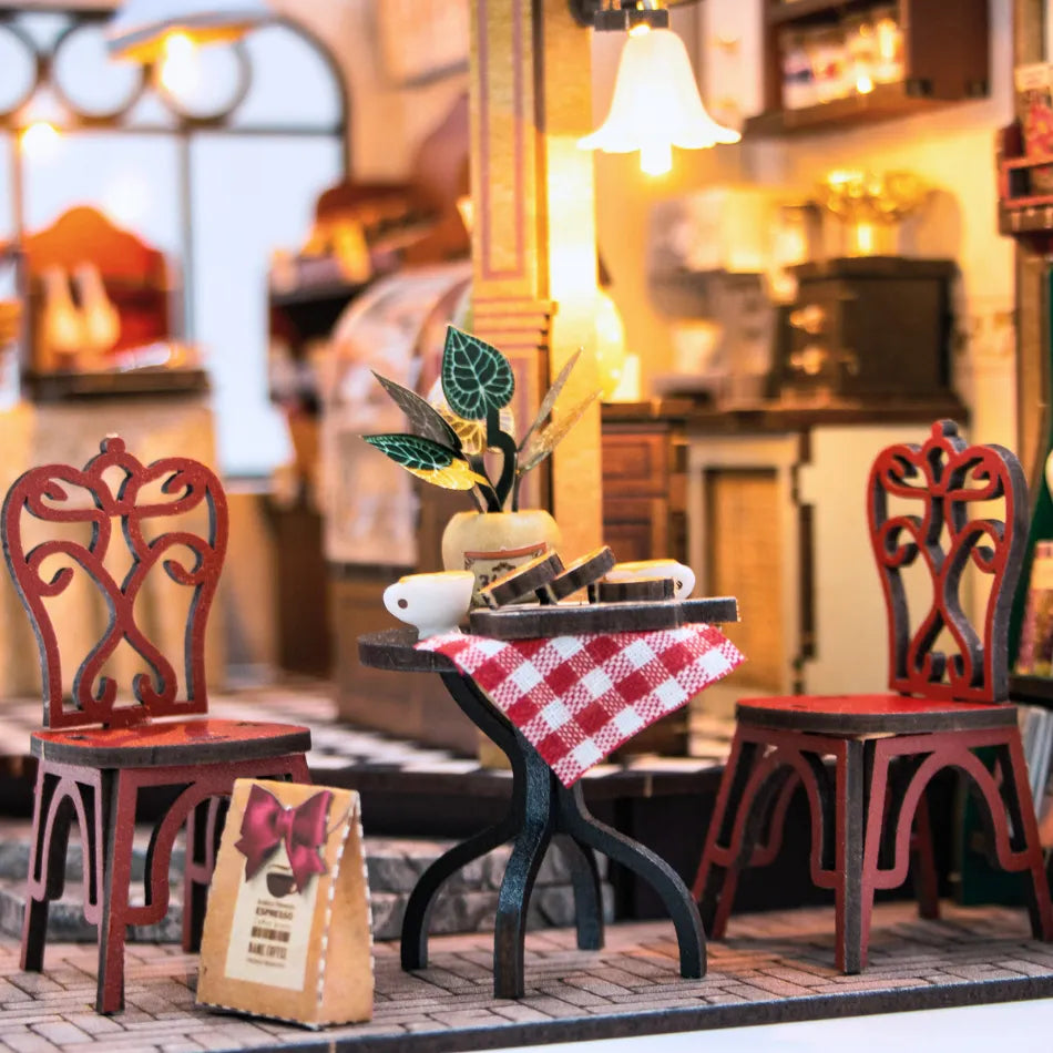 Miniature table with chairs and a checkered tablecloth in a blurred indoor setting