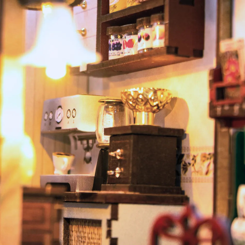 Close-up of a miniature espresso machine with a blurred background