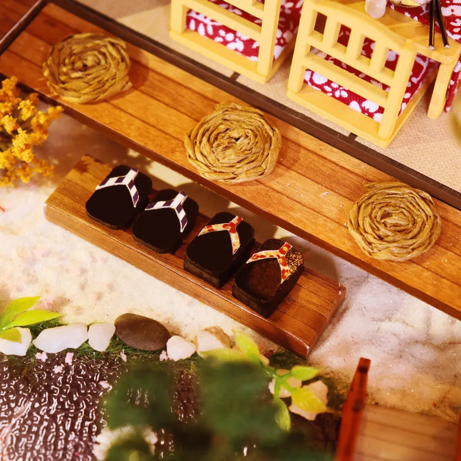 Wooden shelf with decorative items including a small bed, plants, and boxes on a textured surface.