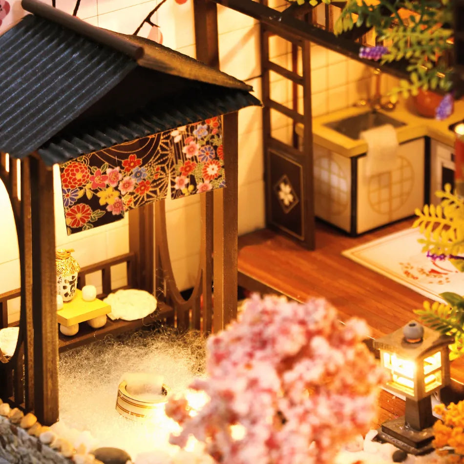 Miniature Japanese-style house with decorative elements and warm lighting