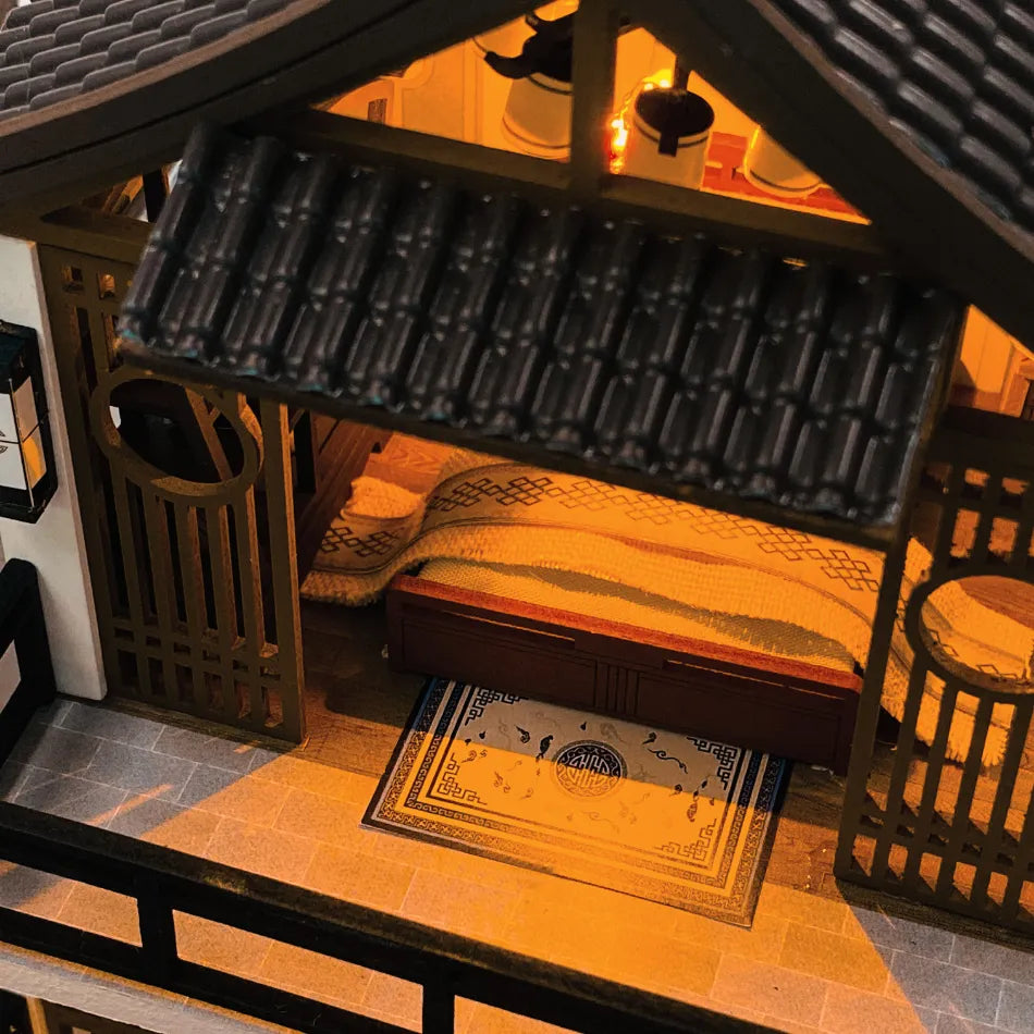 Close-up of a miniature house interior with a rug and door mat.
