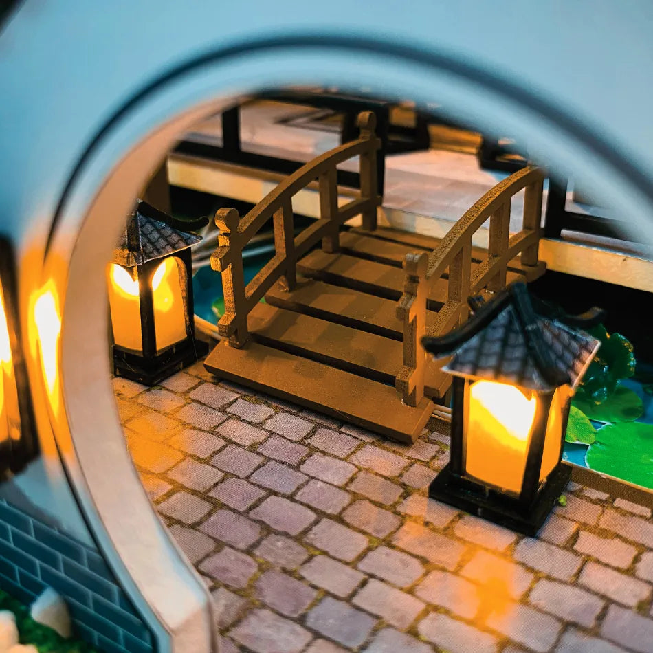 Miniature model of a bridge with lanterns on a cobblestone path