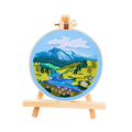 Embroidery hoop with a mountain landscape design on a white background
