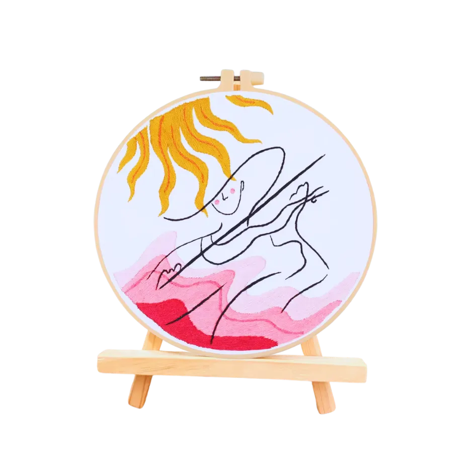 Embroidery hoop with a colorful abstract design on a white background