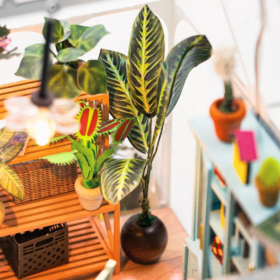 Indoor plants and decor items on a wooden surface with a blurred background