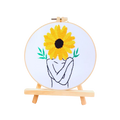 Embroidery hoop with a sunflower design on a white background