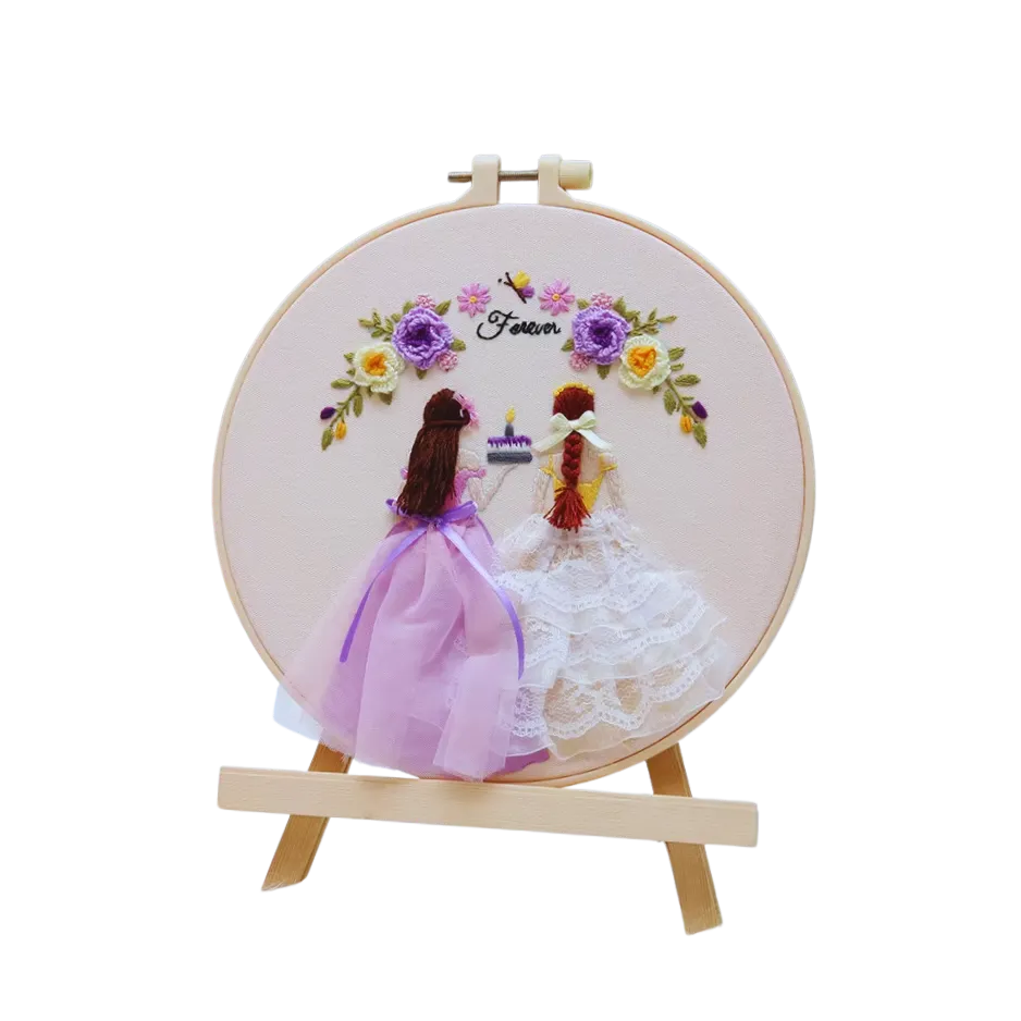 Embroidery hoop with two brides and flowers on a white background