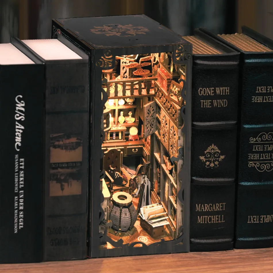 Decorative book with a miniature interior scene, resembling a library or bookstore, on a wooden surface.