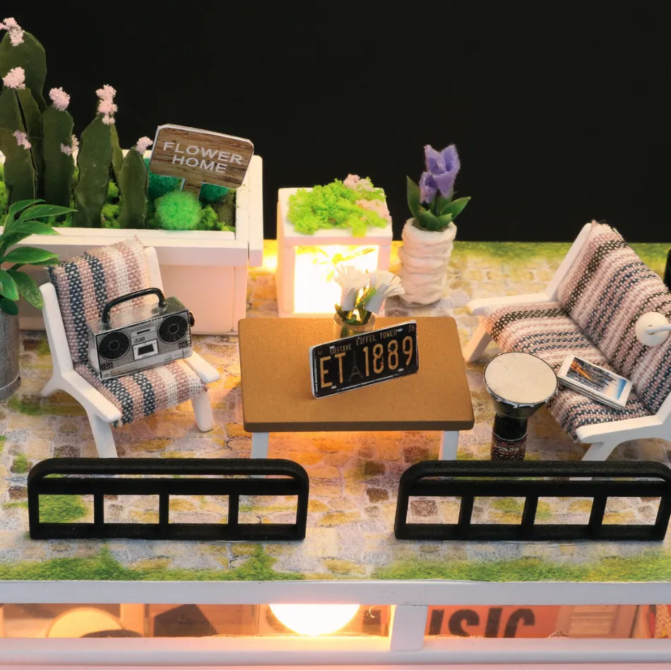 Miniature indoor garden setup with plants, furniture, and decorative items on a table.