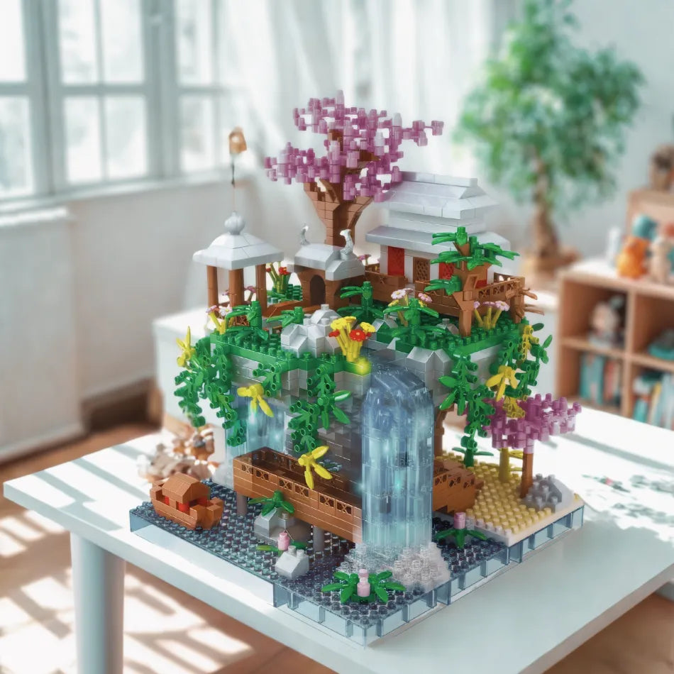 Detailed building block model of a scenic landscape with trees, flowers, and a waterfall on a table.
