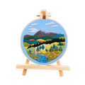 Embroidery hoop with a mountain landscape design on a white background