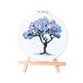 Embroidery hoop with a blue floral tree design on a white background