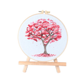 Cross-stitched tree with pink leaves on a white background