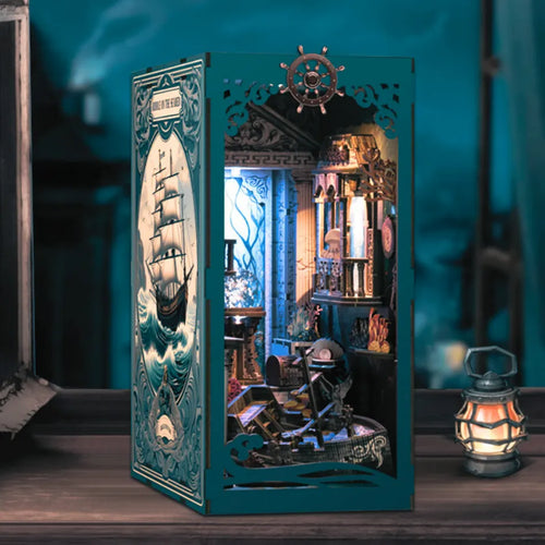 Decorative box with a ship illustration and intricate design on a wooden surface.