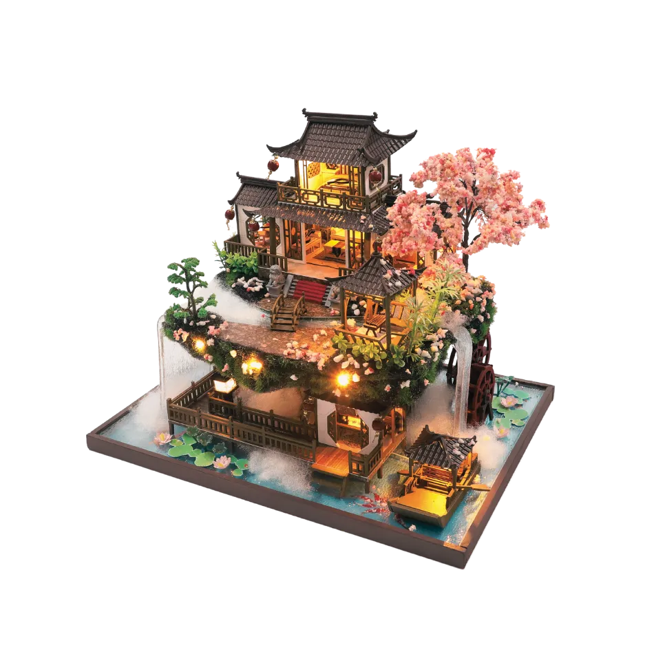 DIY miniature Asian-style watermill house with warm lights, cherry blossom tree, waterfall, and wooden bridges — detailed craft model kit on a transparent background.