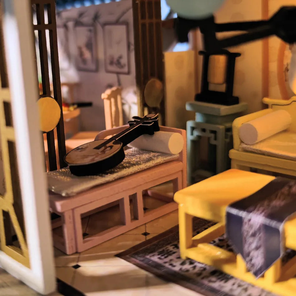 Miniature living room setup with furniture and a guitar