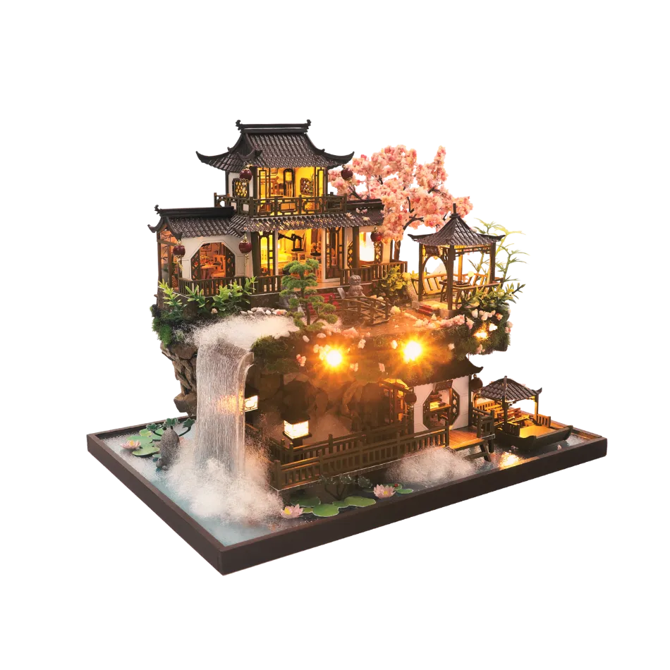 DIY miniature Asian-style watermill house with warm lights, cherry blossom tree, waterfall, and wooden bridges — detailed craft model kit on a transparent background.