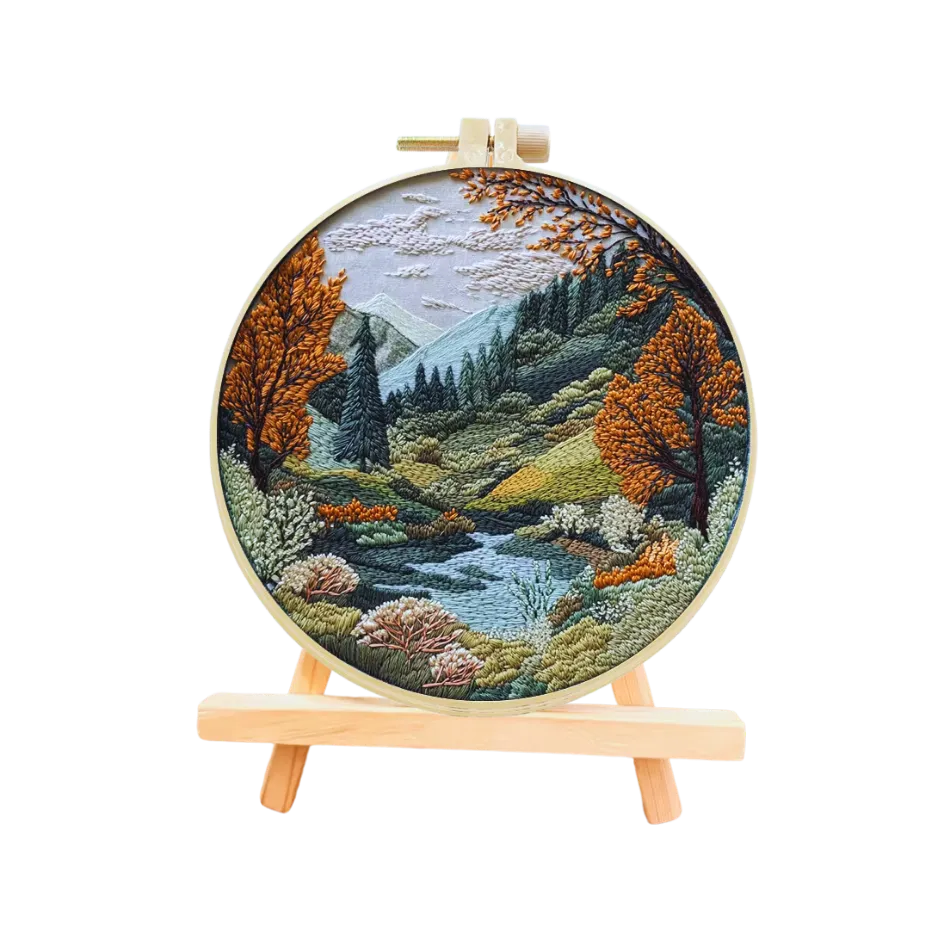 Embroidery hoop with a scenic landscape design on a white background