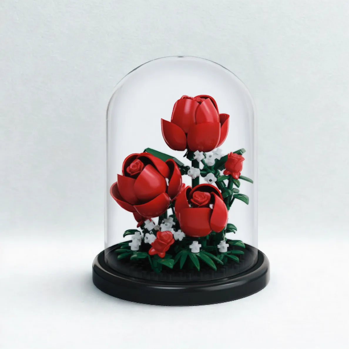 roses displayed under a clear dome cover on a black base